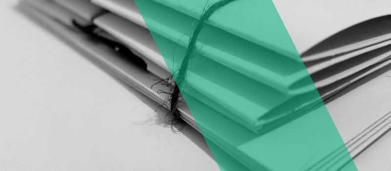 A black and white photo of a stack of documents.